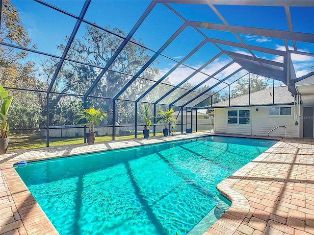 view of swimming pool featuring a lanai and a patio area