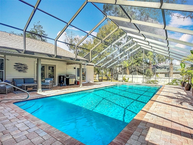 view of swimming pool with outdoor lounge area, a lanai, and a patio