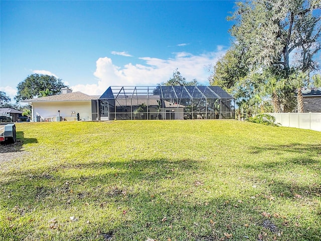 view of yard with glass enclosure