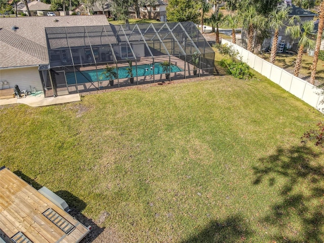 view of yard with a lanai, a fenced in pool, and a patio area