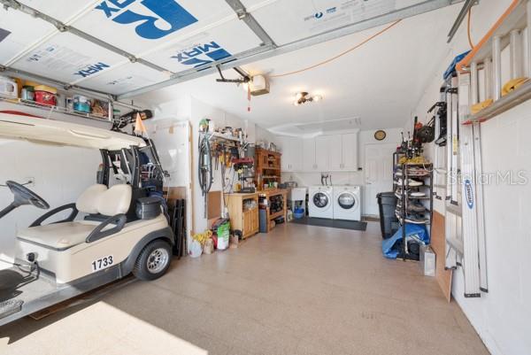 garage featuring a garage door opener and washer and dryer