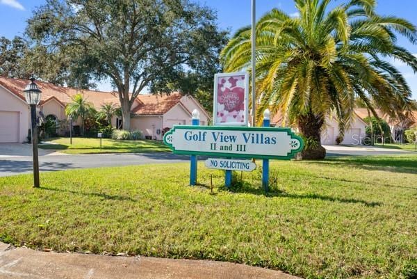 community / neighborhood sign with a lawn