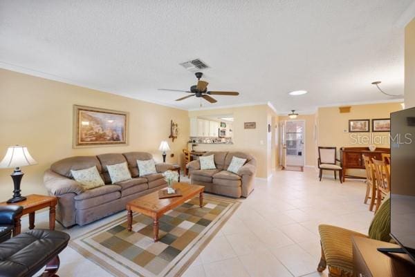 living room with ornamental molding and ceiling fan