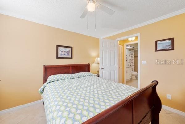 tiled bedroom with ornamental molding and ceiling fan