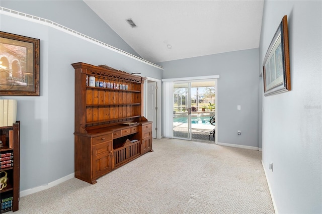 carpeted living room with vaulted ceiling