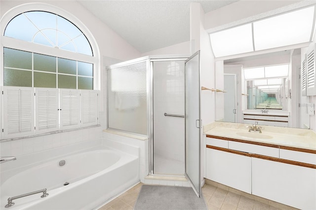 bathroom with tile patterned floors, plus walk in shower, a textured ceiling, and vanity