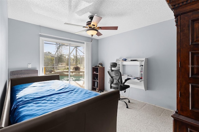 carpeted bedroom featuring ceiling fan, access to exterior, and a textured ceiling