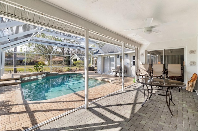 view of pool featuring a lanai, a patio area, and ceiling fan