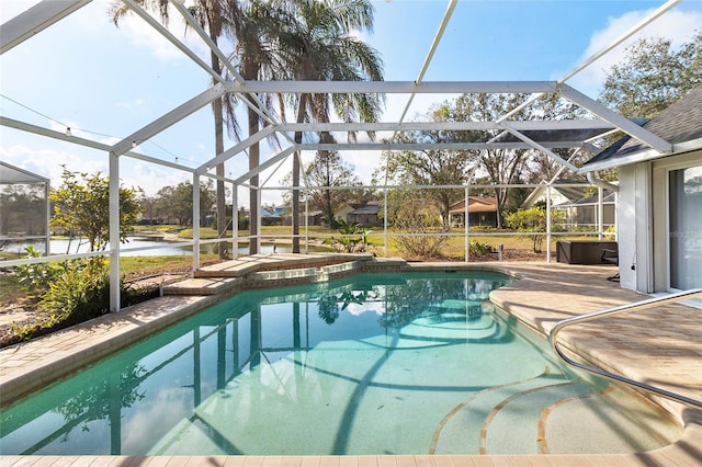 view of swimming pool with a patio, a water view, an in ground hot tub, and a lanai