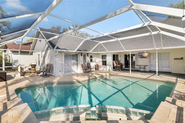 view of pool featuring a patio area and glass enclosure