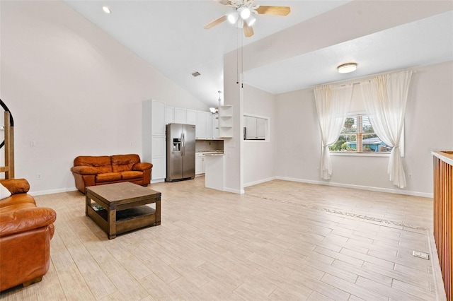 living room with high vaulted ceiling, ceiling fan, and light wood-type flooring