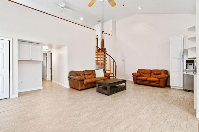 living room featuring high vaulted ceiling, ceiling fan, and light hardwood / wood-style flooring