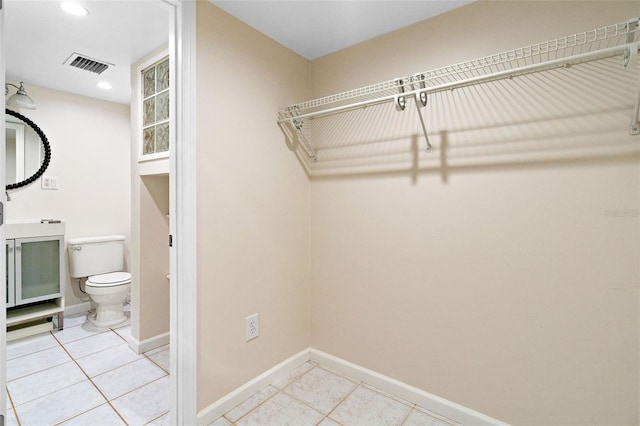 walk in closet featuring light tile patterned flooring