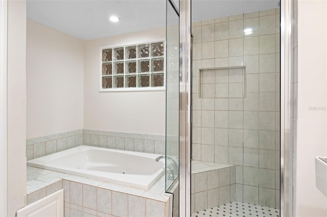 bathroom featuring separate shower and tub