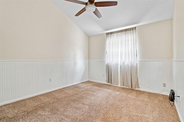 unfurnished room featuring vaulted ceiling, carpet flooring, and ceiling fan