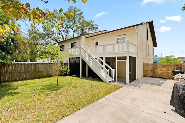 rear view of property featuring a lawn