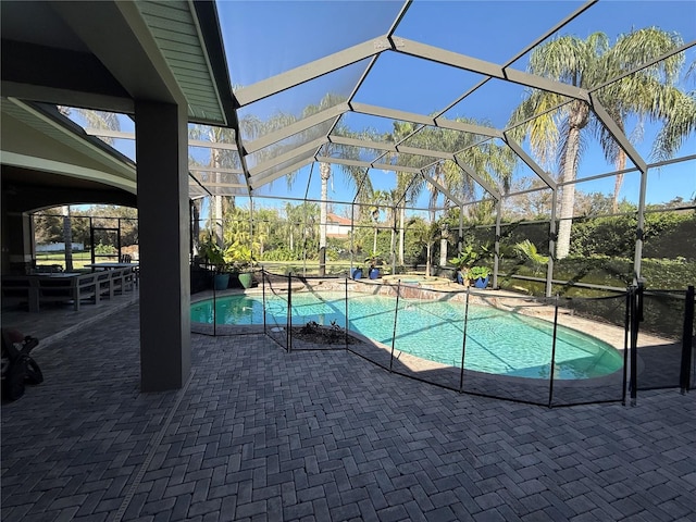 view of pool featuring a lanai, a patio area, and a pool with connected hot tub