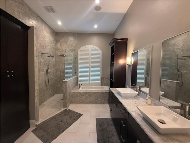 full bathroom featuring a walk in shower, a sink, a bath, and tile patterned floors