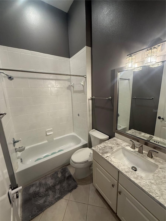 full bathroom featuring tile patterned flooring, toilet, bathing tub / shower combination, and vanity