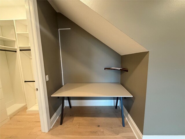 interior space featuring light wood-style flooring and baseboards