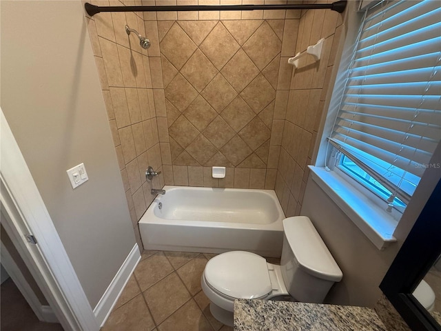 full bathroom with toilet, tile patterned floors, baseboards, and shower / bathing tub combination