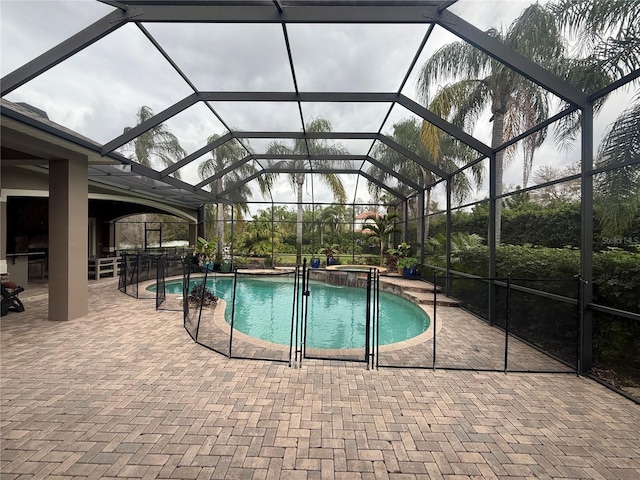 view of swimming pool featuring a pool with connected hot tub, a lanai, and a patio