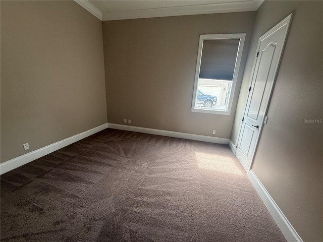 carpeted empty room featuring ornamental molding and baseboards