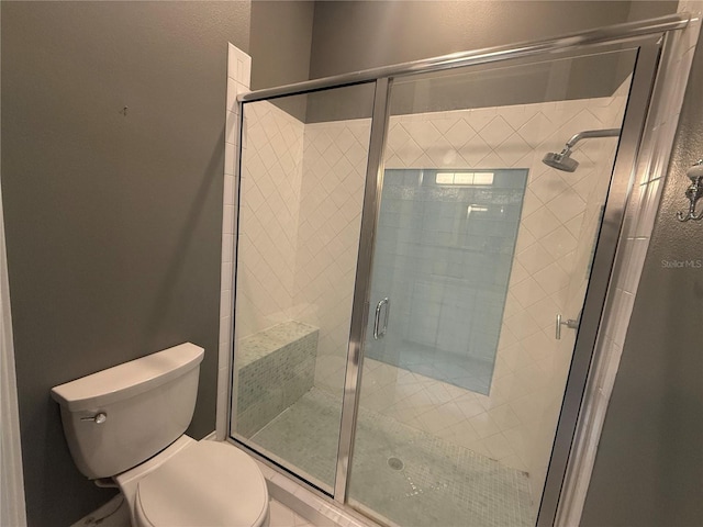 full bath with a shower stall and toilet