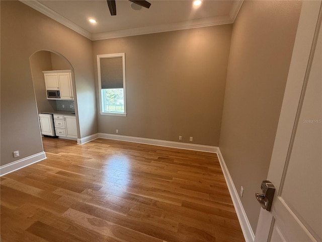 unfurnished room featuring recessed lighting, crown molding, baseboards, and wood finished floors