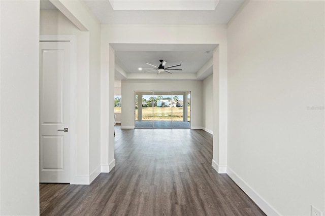 corridor featuring dark hardwood / wood-style floors and a raised ceiling