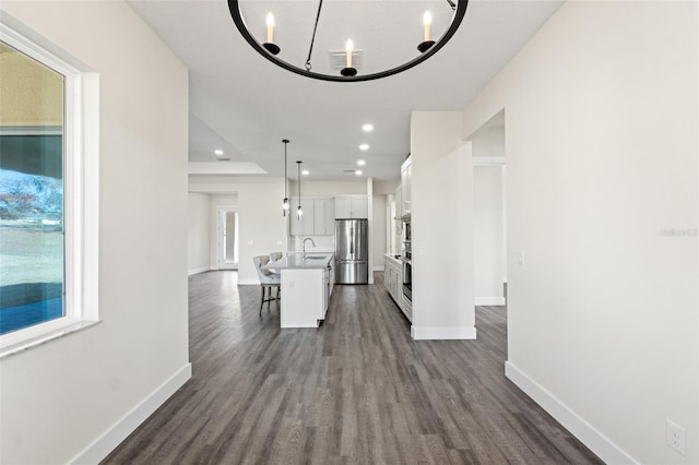 interior space featuring dark hardwood / wood-style floors, sink, and a notable chandelier