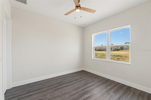 spare room with dark hardwood / wood-style floors and ceiling fan