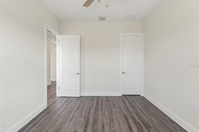 unfurnished bedroom featuring dark hardwood / wood-style floors and ceiling fan