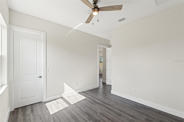 unfurnished bedroom featuring dark wood-type flooring and ceiling fan