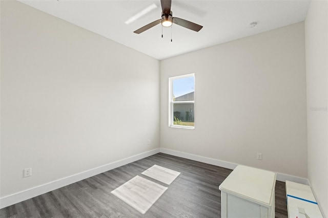 empty room with dark wood-type flooring and ceiling fan