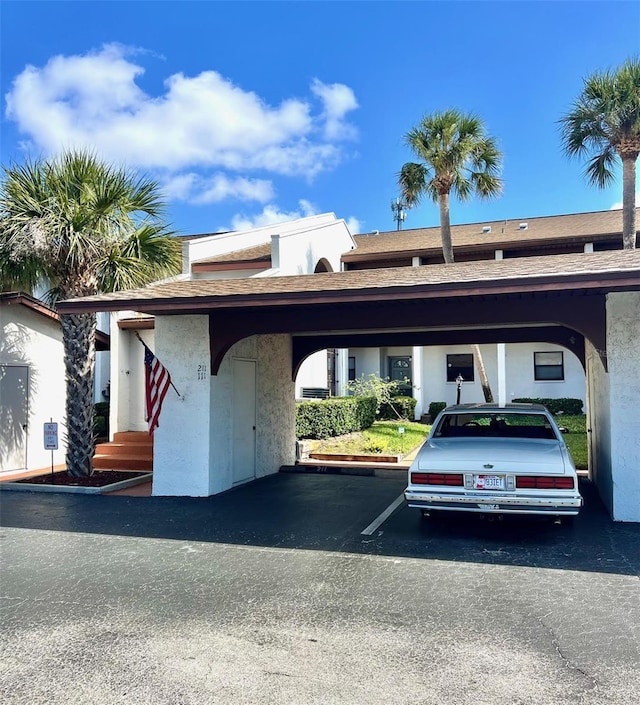 view of parking / parking lot featuring a carport