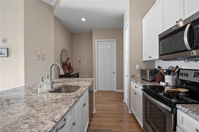 kitchen with white cabinetry, stainless steel appliances, and sink