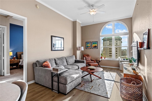 living room featuring crown molding, ceiling fan, and hardwood / wood-style flooring