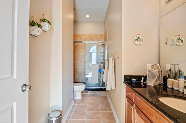 bathroom featuring an enclosed shower, vanity, tile patterned flooring, and toilet