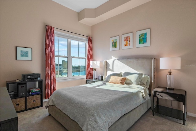 carpeted bedroom with a water view