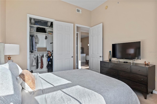 bedroom with light carpet and a closet