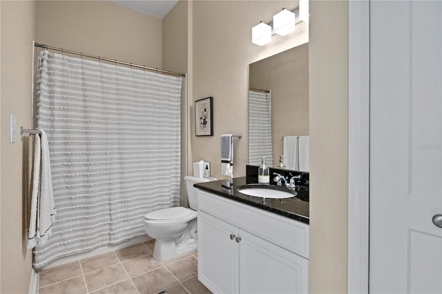 bathroom with tile patterned flooring, vanity, and toilet