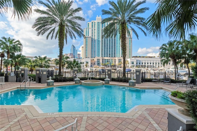 view of pool with a patio area and a community hot tub