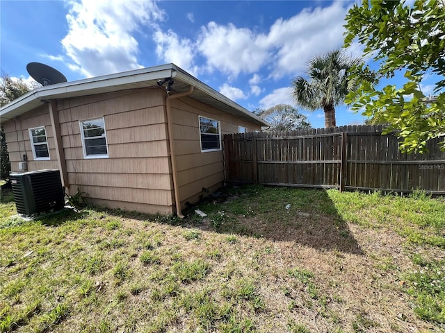 7563 Meadowlawn Dr N, Saint Petersburg, FL 33702 - view of home's exterior featuring central AC unit and a lawn