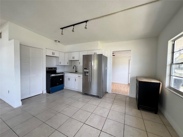 7563 Meadowlawn Dr N, Saint Petersburg, FL 33702 - kitchen with sink, electric range, high quality fridge, white cabinets, and light tile patterned flooring