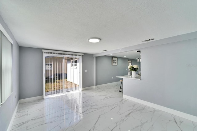 empty room featuring a textured ceiling