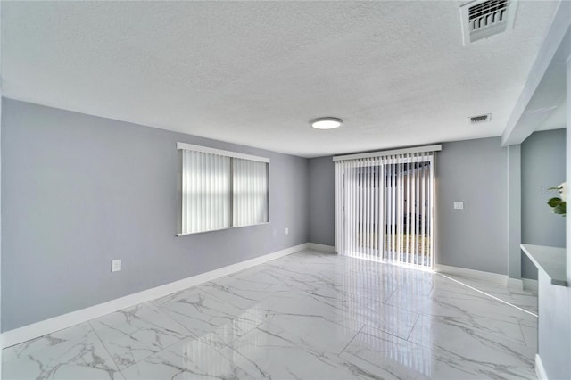 empty room featuring a textured ceiling