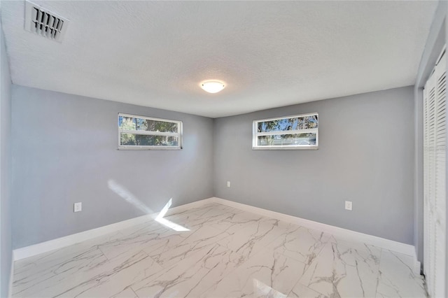 empty room with a textured ceiling