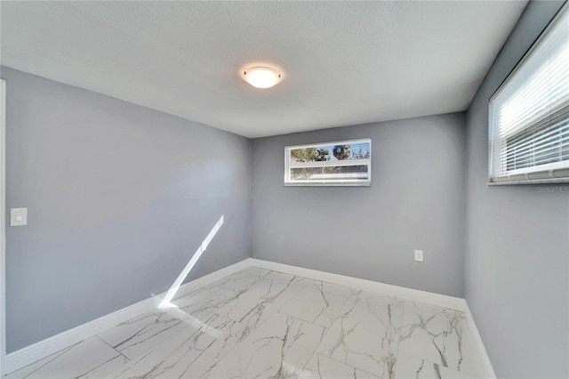 spare room featuring a textured ceiling