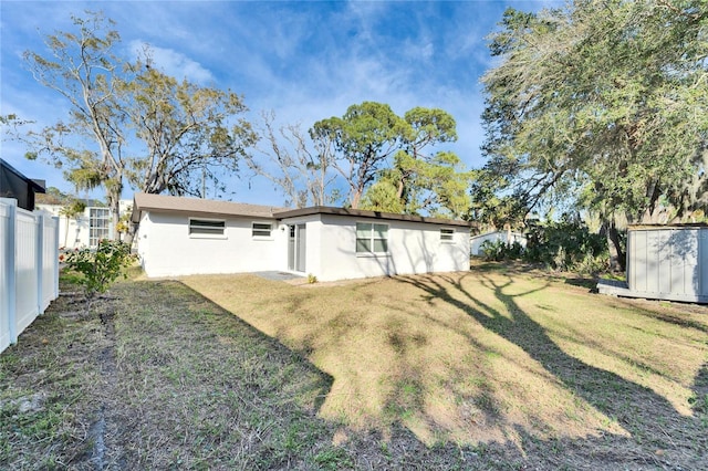 rear view of property featuring a yard